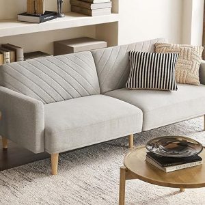 This convertible sofa bed is perfect for small apartments and studio living. Its split-back design allows for customized comfort, while the tapered legs and linen upholstery add a touch of modern style